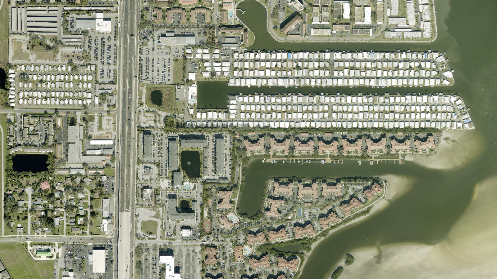 Aerial view of Grand Bellagio at Baywatch and the Old Tampa Bay shoreline in Clearwater, Florida